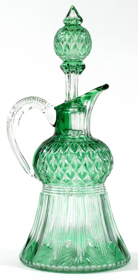 STEVENS & WILLIAMS GREEN-TO-CLEAR GLASS DECANTER: STEVENS & WILLIAMS 'THISTLE' GREEN-TO-CLEAR GLASS DECANTER, C. 1910, H 8":Thistle form whiskey decanter with stopper by Stevens and Williams. Green cut to clear decorated glass, unmarked. Measuring H.