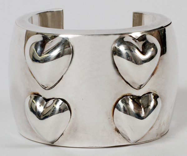 BRENDA SCHOENFELD MEXICAN STERLING CUFF BRACELET: BRENDA SCHOENFELD, MEXICAN STERLING CUFF BRACELET:Four applied heart accents; stamped (see additional photo). Measures W.2 3/4" x 1 7/8", and weighs approximately 2.8 troy oz.