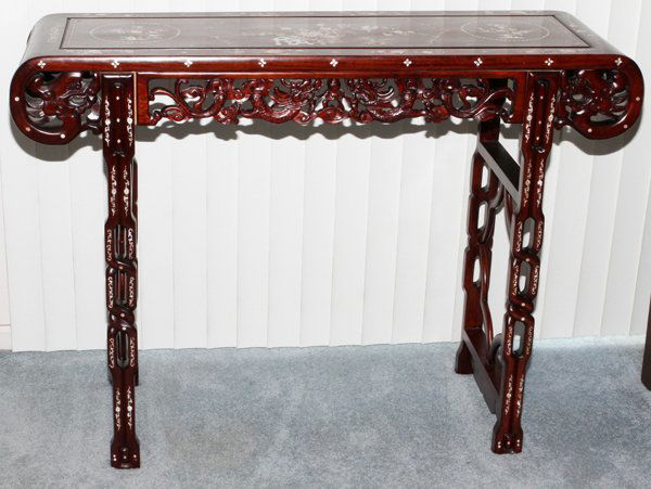 CHINESE TEAKWOOD & MOTHER-OF-PEARL ALTAR TABLE: CHINESE TEAKWOOD & MOTHER-OF-PEARL ALTAR TABLE, H 36", W 48", D 16":The top inlaid with mother-of-pearl bird and floral reserves, pierced dragon and floral apron. Mid 20th century.
