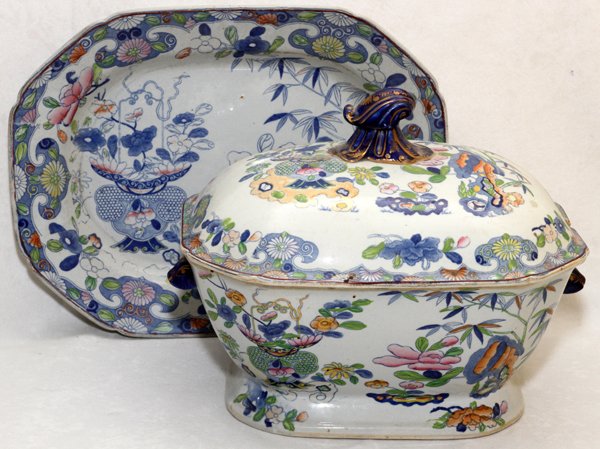ENGLISH IRONSTONE TUREEN & UNDER TRAY 19TH C.: ENGLISH IRONSTONE TUREEN & UNDER TRAY, 19TH C., H 9" L 12":Decorated in Oriental floral motif. Marked at the underside, "Patent Ironstone China". Tureen measures H. 9 1/2" x 12", tray measures L. 14 1