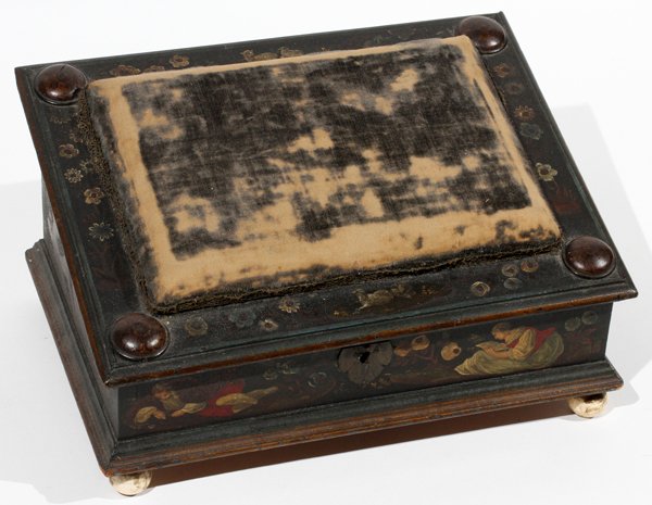 CONTINENTAL PAINTED WOOD SEWING BOX 19TH C.: CONTINENTAL PAINTED WOOD SEWING BOX, 19TH C., H 6 1/2", W 12", D 9":The slanted tops is centered by a pin cushion, hinging open to a painted interior fitted with a hinged compartment and three small d