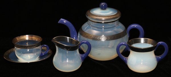 FRY FOVAL GLASS TEA SET EARLY 20TH C. 15 PIECES: FRY FOVAL GLASS TEA SET, EARLY 20TH C., FIFTEEN PIECES:Including 1 teapot, H.6 1/2", 1 creamer, 1 sugar bowl, 6 tea cups with 6 saucers; each piece is trimmed with a silver foliate band, the teapot an