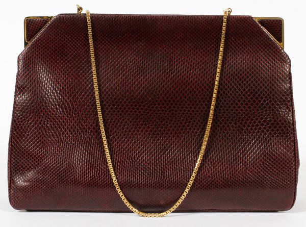 JUDITH LEIBER LIZARD SHOULDER BAG: JUDITH LEIBER LIZARD SHOULDER BAG, W 10":A burgundy lizard bag with gold tone accents, opening to coordinating satin lining. Labeled: Judith Leiber. Measures W.10" x 7" (26" to the shoulder strap). Wi