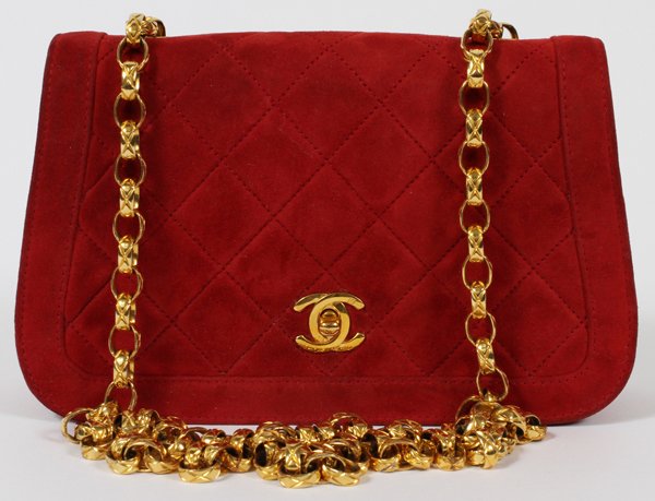 CHANEL QUILTED RED SUEDE SHOULDER BAG: CHANEL QUILTED RED SUEDE SHOULDER BAG, W 8":A single flap at the front and exterior pocket at the reverse, with a logo turnlock opening to a red leather lined interior fitted in two sections, stamped,