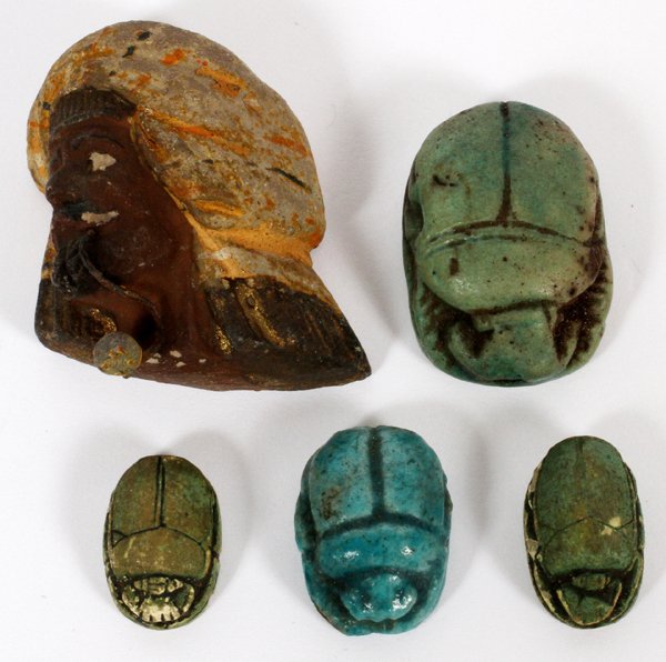 FAIENCE SCARABS& POTTERY HEAD OF A MOOR: FAIENCE SCARABS (4) & POTTERY HEAD OF A MOOR, L 1/2"-1 1/4":Including 4 faience scarabs, one of which is glazed blue, and 1 pottery head of a Moor, not marked. Five items total.