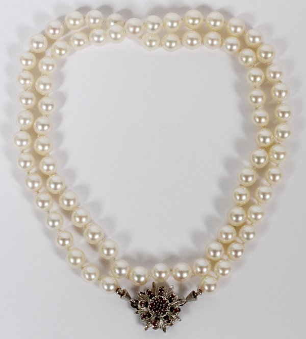 7MM FRESH WATER PEARL LADY'S NECKLACE: 7MM FRESH WATER PEARL LADY'S NECKLACE, L 24":Lady's single strand, 7mm dia. Pearl necklace, fitted with a 14kt white gold flower form clasp, featuring round rubies prong set throughout, measuring L. 2