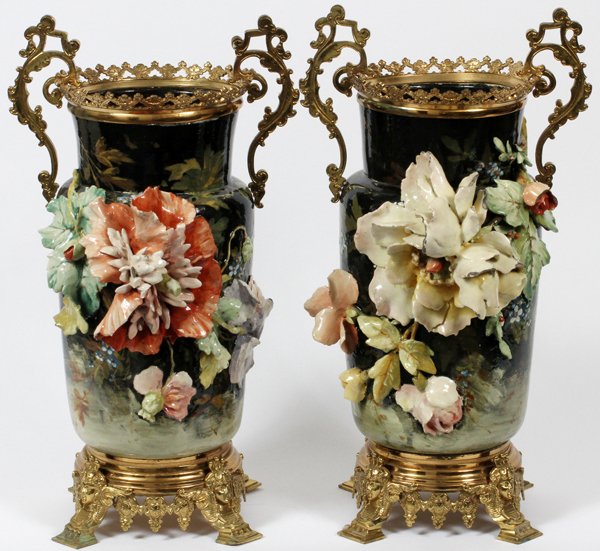 FRENCH MAJOLICA & BRONZE MOUNTED VASES PAIR: FRENCH MAJOLICA & BRONZE MOUNTED VASES, LATE 19TH C., PAIR, H 20":Each is mounted with bronze ormolu handled rims and footed bases, decorated with applied floral arrangement along the body, on a black