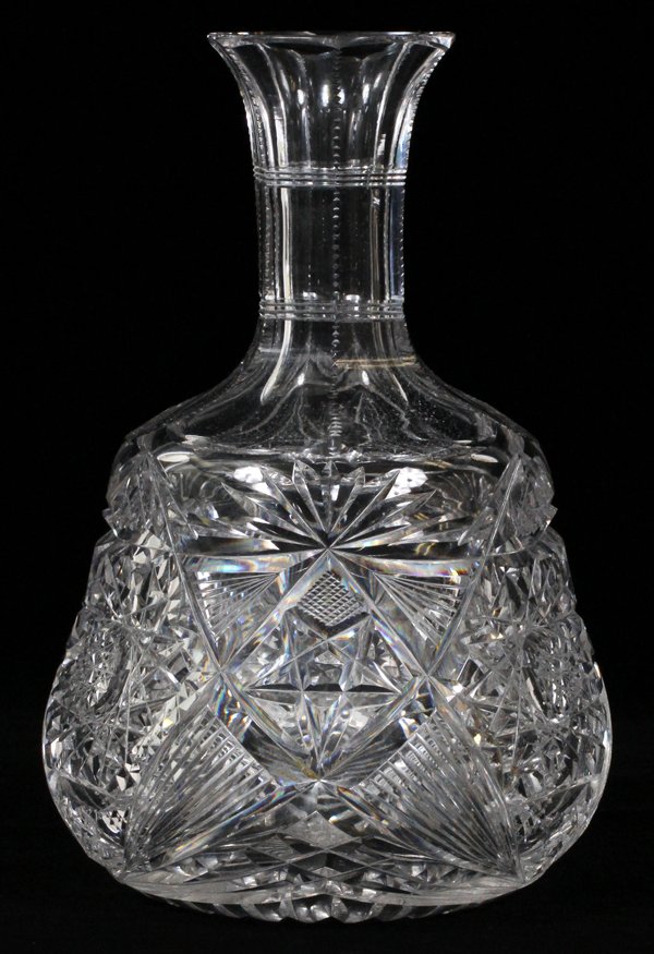LIBBEY BRILLIANT CUT GLASS CARAFE C. 1900: LIBBEY BRILLIANT CUT GLASS CARAFE, C. 1900, H 8 3/4":Having a paneled and notched neck above cut hobstars alternating with miters enclosing star and spear motifs. Acid stamped signature at the shoulde