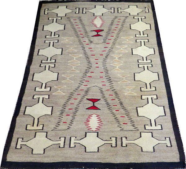 NAVAJO HAND WOVEN RUG C. 1920: NAVAJO HAND WOVEN RUG, C. 1920, 5' 11" X 4' 5":Grey ground with a black border, decorated with cream and red accents. Measuring L. 5 ft. 11 x 4 ft. 5. Circa 1920.