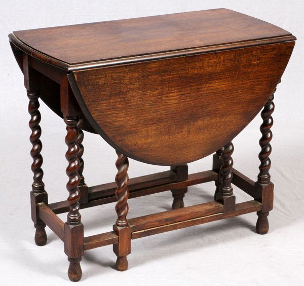 ENGLISH JACOBEAN OAK GATE LEG TABLE: ENGLISH JACOBEAN OAK GATE LEG TABLE H 29", L 45", D 34":The antique English drop leaf table features turned gate legs.