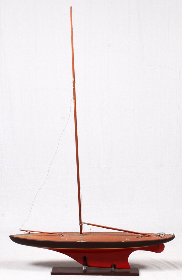 PAINTED WOOD POND BOAT CIRCA 1940'S: PAINTED WOOD POND BOAT, CIRCA 1940'S, H 6' 8", L 49.5", D 9.25":Having a red keel with brown hull above the waterline. Accompanied by a fitted base. Height includes mast.