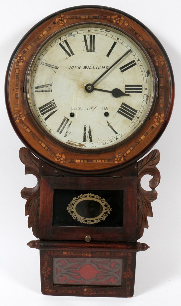 JOHN WILLIAMS WELSH INLAID WALL CLOCK 19TH C.: JOHN WILLIAMS WELSH INLAID WALL CLOCK, 19TH C., H 26 1/2", W 16":Two key wind dial, with Roman numerals, bordered by a parquetry inlaid frame, with carved foliate sides, flanking a center glass panele