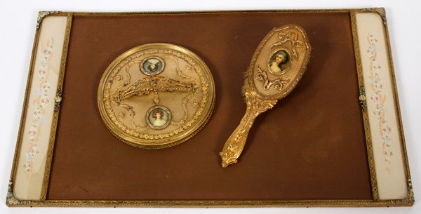 FRENCH STYLE GILT BRONZE DRESSING TABLE SET C1920: FRENCH STYLE, GILT BRONZE, DRESSING TABLE SET, C1920, 3 PCS.,:includes a gilt bronze hair brush, with portrait on bronze back, 9" L. one round gilt bronze hand mirror with two portraits, 7" Dia. And o