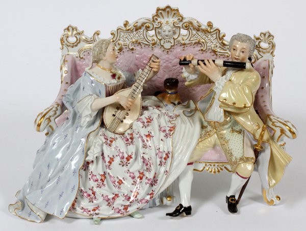 MEISSEN PORCELAIN FIGURE GROUP LATE 19TH-EARLY 20TH: MEISSEN PORCELAIN FIGURE GROUP, LATE 19TH-EARLY 20TH C., H 5 3/5", W 9":Depicting a lady playing the mandolin and a gentleman playing the flute, both seated on settee with a pug dog reclining between 