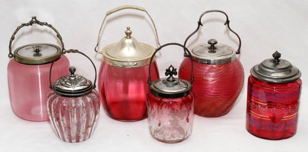 VICTORIAN CRANBERRY GLASS BISCUIT JARS &ANOTHER JAR: VICTORIAN CRANBERRY GLASS BISCUIT JARS (5) & ANOTHER JAR, LATE 19TH C., H 8"-9":Including 5 biscuit, or cracker, jars, one of which Loetz style, together with 1 other jar with enamel decoration; all h