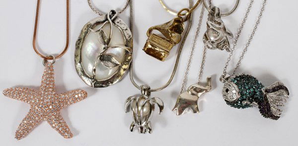 STERLING SILVER PENDANTS AND CHAINS 7 PCS.: STERLING SILVER PENDANTS AND CHAINS, 7 PCS., L 16" - 21":includes on mother of pearl and leaf design, one of a phonograph with horn, one starfish with faceted stone accents, one exotic fish, one eleph