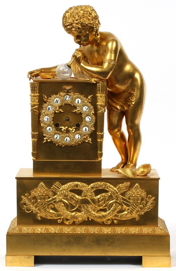 REGENCY GILT BRONZE MANTEL CLOCK 19TH C.: REGENCY GILT BRONZE MANTEL CLOCK, 19TH C., H 19", W 12", D 5", BOY BLOWING A BUBBLE:Raised on a rectangular, bronze ormolu mounted base, depicting a standing child figure blowing a bubble {made of gla
