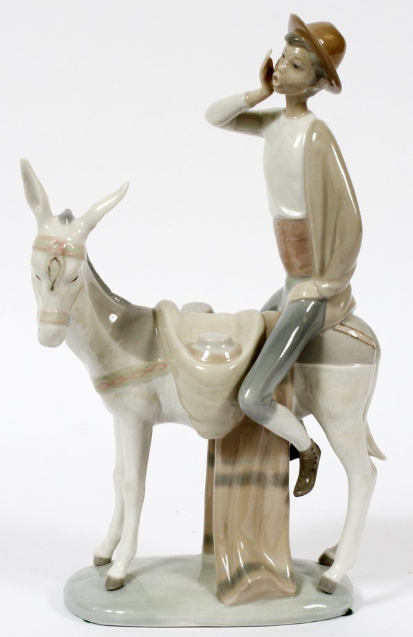 LLADRO PORCELAIN FIGURE: LLADRO PORCELAIN FIGURE, H 11", W 6", BOY ON DONKEY:Depicting a boy riding a donkey, marked at the underside. Measuring H. 11 3/8" x 6 1/4". For a high resolution photo