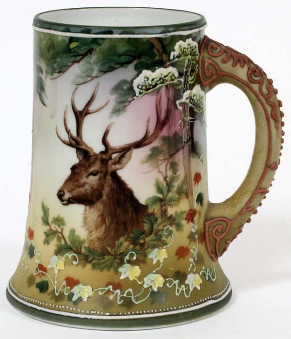 NIPPON HAND-PAINTED PORCELAIN MUG EARLY 20TH C.: NIPPON HAND-PAINTED PORCELAIN MUG, EARLY 20TH C., H 5" W 4 1/4":Fitted with a single handle, decorated with the bust of a stag, surrounded by foliate motif. Measuring H. 5" x 4 1/4". Stamped at the un