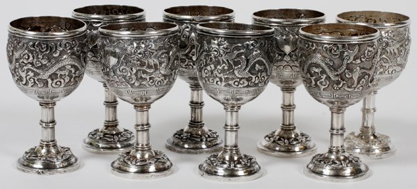 CHINESE SILVER CORDIALS EARLY 20TH C. EIGHT: CHINESE SILVER CORDIALS, EARLY 20TH C., EIGHT, H 3 1/4":A set of 8 cordials, each repousse decorated with dragon figures about the cup. Rubbed markings noted at each stem. Measuring H. 3 1/4", with a 