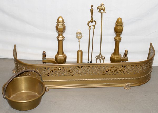 ENGLISH BRASS FENDER ANDIRONS & FIRE TOOLS 7: ENGLISH BRASS FENDER, ANDIRONS & FIRE TOOLS 7 H 9" L 42" D 12":Including 1pierced brass fender with paw feet, 1 brass pail with iron handle, 1 pair of hexagonal andirons, tongs, poker with an elephant