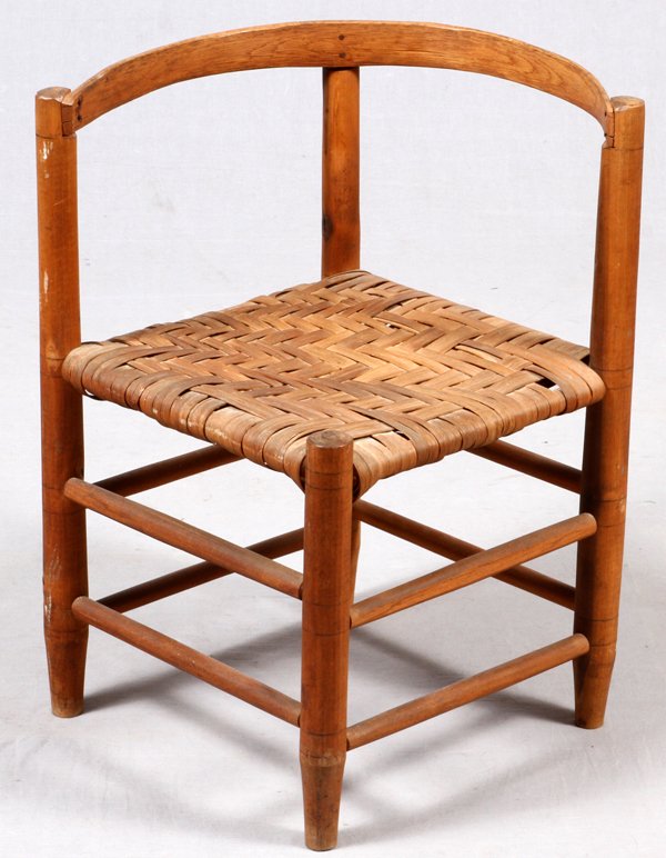 TURNED HARDWOOD CORNER CHAIR, SHAVED WOOD SEAT: TURNED HARDWOOD WOOD CORNER CHAIR, WITH SHAVED WOOD SEAT, H 25", W 22":Having a shaved wood seat, spindle legs, stretchers and bent wood back frame.
