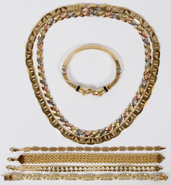 10KT GOLD NECKLACE AND BRACELETS 7 PIECES: 10KT GOLD NECKLACE AND BRACELETS, 7 PIECES:Includes two necklaces, one having multi-color gold links; four link bracelets plus one cuff bracelet having lions heads with red stone eyes.