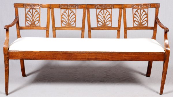 ENGLISH REGENCY STYLE WALNUT SETTEE, 19TH C., L 65": ENGLISH REGENCY STYLE WALNUT SETTEE, 19TH C., L 65":Having a four-chair back design, with pierced splats, and a carved swag motif along the undulating rail. Raised on square tapering legs, and fitted 