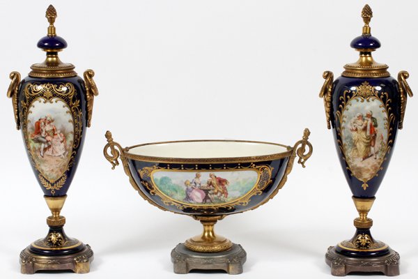 FRENCH PORCELAIN & ORMOLU-MOUNTED GARNITURE SET: FRENCH PORCELAIN & ORMOLU-MOUNTED GARNITURE SET, 20TH CENTURY, THREE PIECES, H 16", W 13":Including 1 oblong centerpiece bowl, H.9" x 13", and a pair of covered urns, H.16" (fixed covers); depicting c