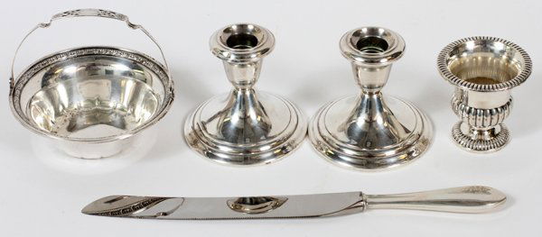 AMERICAN STERLING TABLEWARE FIVE PIECES: AMERICAN STERLING TABLEWARE, FIVE PIECES:Sterling silver grouping includes 1 La Pierre candy/bon bon basket, Dia.5"; a pair of Gorham weighted candlesticks, H.3 1/2"; 1 serrated cake knife with sterli