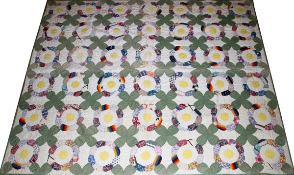 HANDMADE QUILT, 'FLOWER GARDEN', 6' 5" X 5' 3": HANDMADE QUILT, 'FLOWER GARDEN' 6' 5" X 5' 3": Grandma's flower garden design. Sage green on white and multi colors. Lined. Hand made.