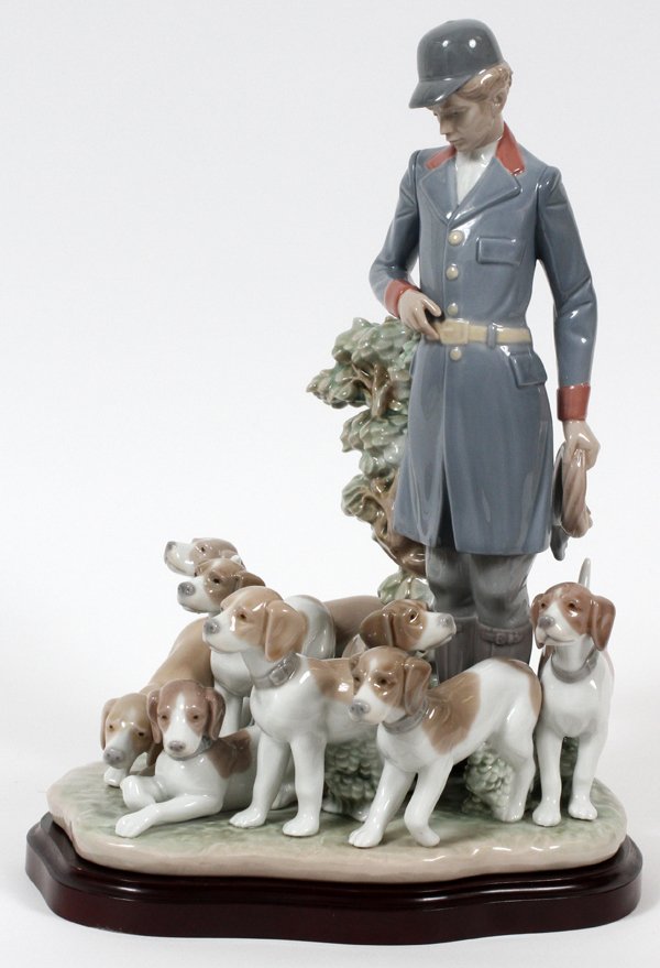 LLADRO PORCELAIN 'PACK OF HUNTING DOGS', H 13 3/4": LLADRO PORCELAIN FIGURE GROUP, 'PACK OF HUNTING DOGS', H 13 3/4", #5342:Figure of a man standing in blue hunting attire with eight hounds at his feet; artist signed underneath (see additional photo),