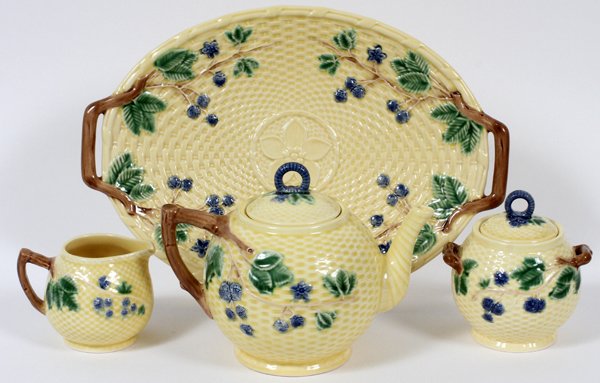 PORTUGUESE MAJOLICA TEA WARE FOR TIFFANY & CO.: PORTUGUESE MAJOLICA STYLE TEA WARE FOR TIFFANY & CO., FOUR PIECES:Including 1 teapot, 1 creamer, 1 covered sugar bowl, and 1 oval tray. Each decorated in yellow with floral and basket weave motif.