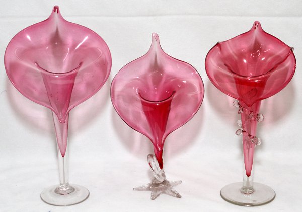VICTORIAN CRANBERRY GLASS JACK-IN-THE-PULPIT VASES: VICTORIAN CRANBERRY GLASS JACK-IN-THE-PULPIT VASES, LATE 19TH C., THREE, H 9 1/2"-10":Each is on a clear base, one of which with a ring holder.