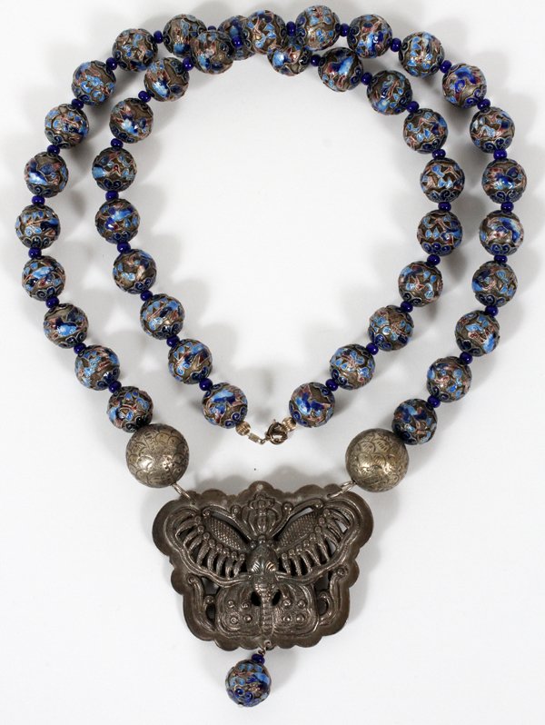 JEANNE HACKETT CHINESE ENAMEL BEAD NECKLACE: JEANNE HACKETT (1919-2014) CHINESE ENAMEL BEAD NECKLACE WITH BUTTERFLY PENDANT, L 32": Enameled metal beads alternating with bright blue bead spacers, hung with a stylized butterfly pendant. Jeanne Ha