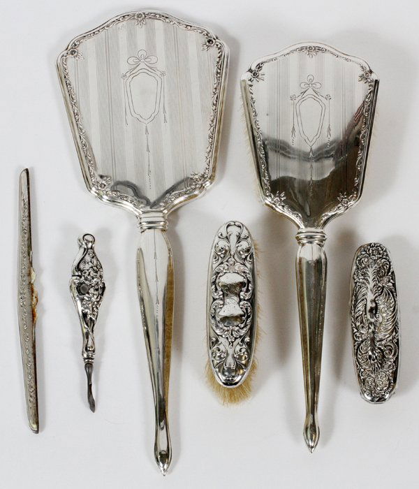 INTERNATIONAL STERLING DRESSER ACCESSORIES 5 PCS.: INTERNATIONAL STERLING DRESSER ACCESSORIES 5 PCS.:Sterling hand mirror (beveled) and hair brush by International. Hand mirror 13". No monograms. Also non matching small brush, nail buffer, cuticle cut