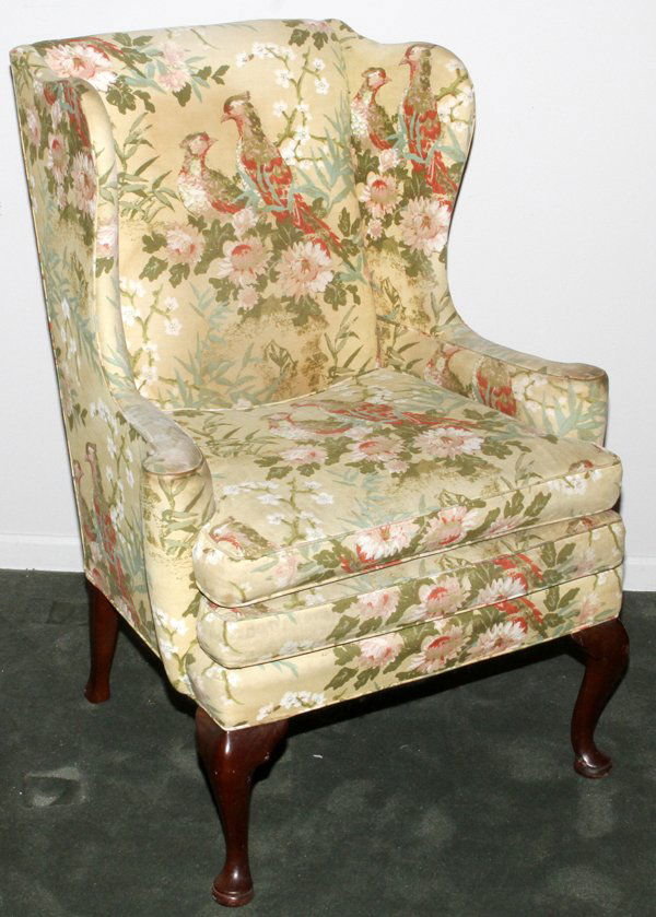 GEORGIAN STYLE WINGBACK CHAIR EARLY 20TH C.: GEORGIAN STYLE UPHOLSTERED WINGBACK CHAIR, EARLY 20TH C.:Upholstered in cotton, with bird and flowering branch motif, raised on mahogany legs with pad feet.