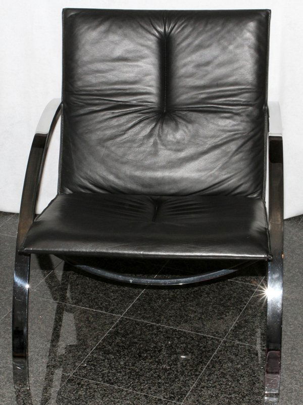 MODERN LEATHER & STEEL LOUNGE CHAIR: MODERN LEATHER & STEEL LOUNGE CHAIR, H 30", W 26":Black leather upholstered seat and back, with curved steel arms. Measuring H. 30" x 26 1/4". Possibly manufactured by Brueton Furniture.