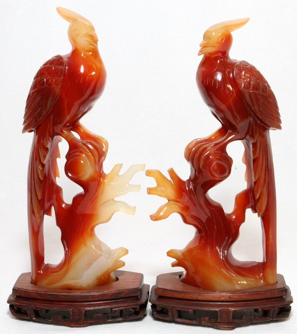 CHINESE CARVED CARNELIAN PERCHED BIRDS PAIR: CHINESE CARVED CARNELIAN PERCHED BIRDS, PAIR, H 5 1/2":Each is mounted on a wood base.