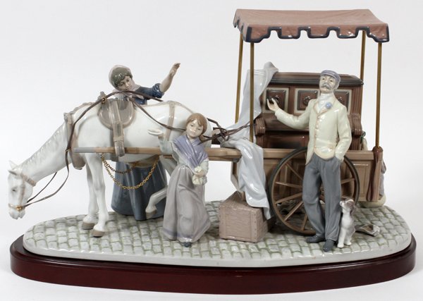 LLADRO PORCELAIN FIGURE GROUP 'STREET HARMONIES': LLADRO PORCELAIN FIGURE GROUP, 'STREET HARMONIES', H 12", L 21 1/2", #5692:An organ grinder with cart, woman and child alongside. On a separate wood base.