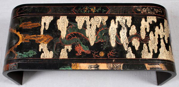 CHINESE BLACK LACQUER COFFEE TABLE: CHINESE BLACK LACQUER COFFEE TABLE, H 15", L 36", D 16":A curved form coffee table, polychrome decorated in white and red. Measuring H. 15 1/2" x 36" x 16". For a high resolution photo