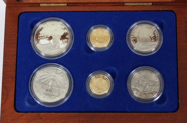 U.S. 6-PC COIN SET FRUITWOOD CASE GOLD SILVER ETC: U.S. 6-PC COIN SET, FRUITWOOD CASE GOLD SILVER ETC, 1986:6 piece coin set with documents included, with original boxes, with a fruit-wood display case. For a high resolution photo