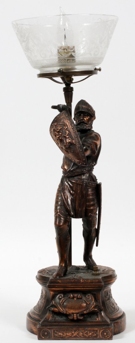 FRENCH COPPER-PLATED FIGURAL NEWEL POST LAMP: FRENCH COPPER-PLATED FIGURAL NEWEL POST LAMP, C. 1900, H 21 1/4", W 6":Depicting a standing knight figure, acting as the light's support. Fitted with an etched glass shade. Made in France for the Amer