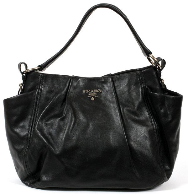 PRADA BLACK LEATHER BAG: PRADA BLACK LEATHER BAG, W 16":A black leather bag flanked by exterior pockets, clips open to a fabric lined interior; labeled: Prada, Milano at the exterior and interior, measuring H. 10 1/2" x 16",