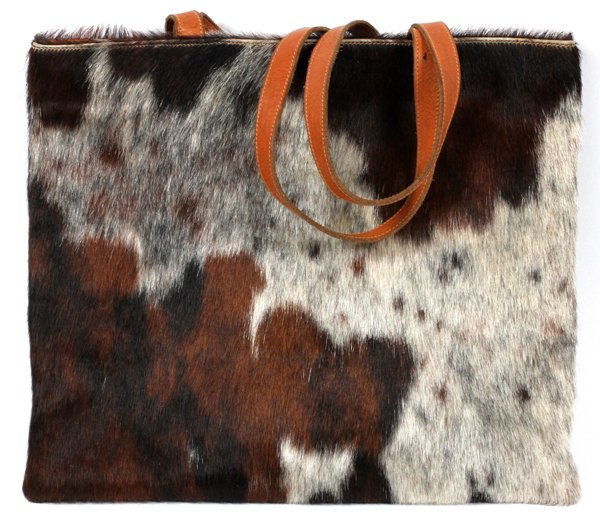 WANNY DI FILIPPO COWHIDE SHOULDER BAG: WANNY DI FILIPPO COWHIDE SHOULDER BAG, W 15":A cowhide shoulder bag, fitted with tan leather handles, opens to a fabric lined interior with a single zippered pocket; labeled: Designed by Wanny Di Fili