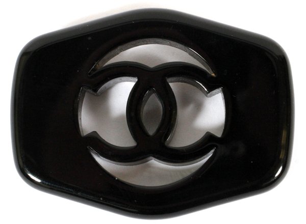 CHANEL BLACK RESIN LOGO BROOCH: CHANEL BLACK RESIN LOGO BROOCH, W 2 1/4":Pierced CC signature logo at the center. Labeled: Chanel, 97 P, Made in France. For a high resolution photo CLICK HERE