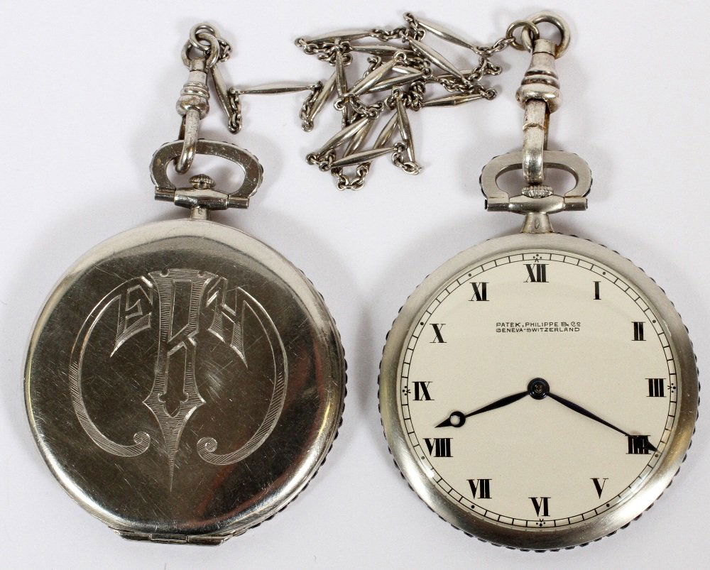 PATEK PHILIPPE PLATINUM OPEN FACE POCKET WATCH: PATEK PHILIPPE PLATINUM OPEN FACE POCKET WATCH & MATCHING LOCKET FOB, 2 PIECES ATTACHED WITH A PLATINUM CHAIN, DIA OF EACH: 1 5/8":Both watch and locket fob have edges jeweled with sapphires; monogram