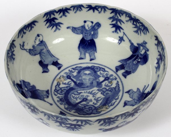 CHINESE PORCELAIN BLUE & WHITE BOWL: CHINESE PORCELAIN BLUE & WHITE BOWL, DIA 10 1/2":Having a blue and white design with figures in the well with leaves and dragon in the center. Additional figures on the outside. Signed. For a high res