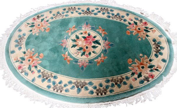CHINESE RUG 6' 0" X 4' 0": CHINESE RUG, 6' 0" X 4' 0":Chinese oval rug, having a light green ground, one large border with floral motif. Large central medallion of flowers. Continuous fringe at the edge. For a high resolution p