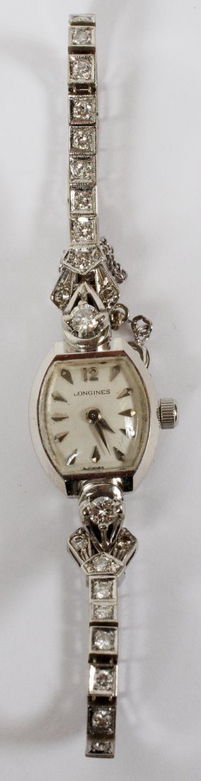 LONGINES 14KT GOLD & DIAMOND LADY'S WRISTWATCH: LONGINES 14KT WHITE GOLD & DIAMOND LADY'S WRISTWATCH:A lady's 14KT white gold and diamond watch. Face measures 1/2" H. x 7/16" W. 15.6 grams total wt. For a high resolution photo